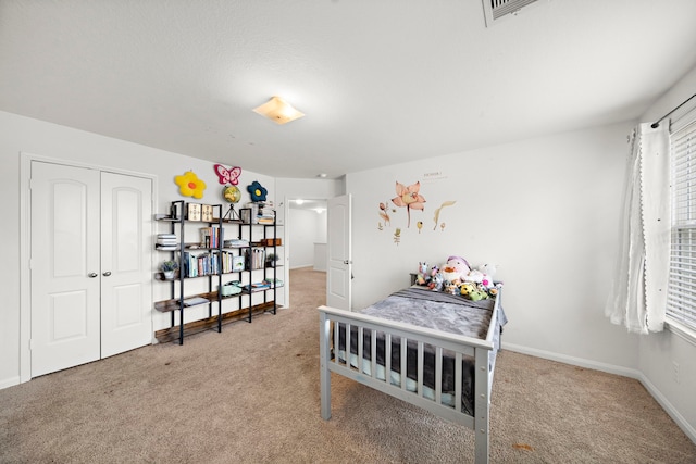 carpeted bedroom with a closet