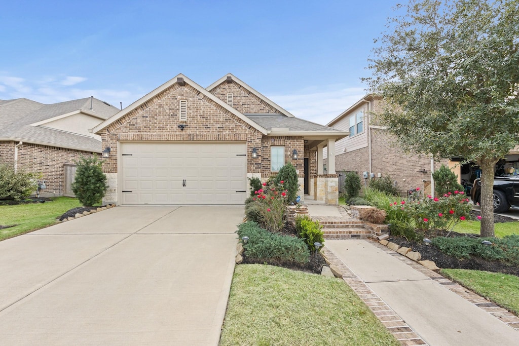 view of front of property featuring a garage and a front yard