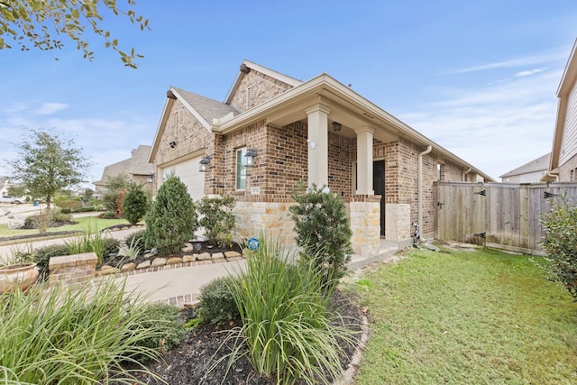 view of side of property featuring a garage and a yard