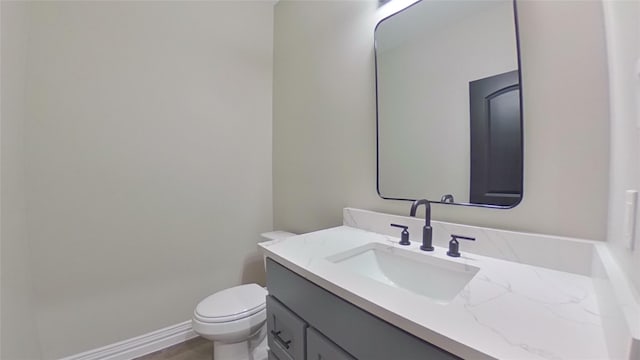 bathroom featuring toilet and vanity