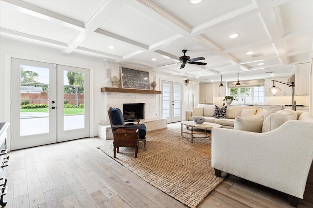 living room featuring beam ceiling, french doors, and coffered ceiling