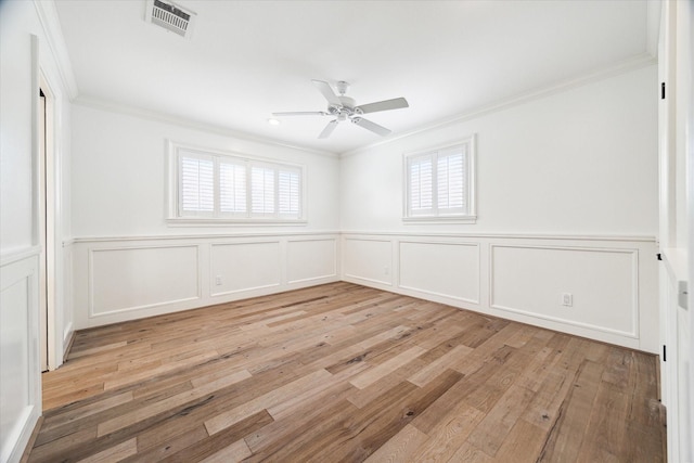 spare room with ceiling fan, light wood-type flooring, and crown molding