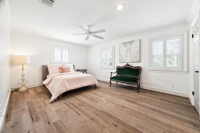 bedroom featuring light wood-type flooring, ceiling fan, and ornamental molding