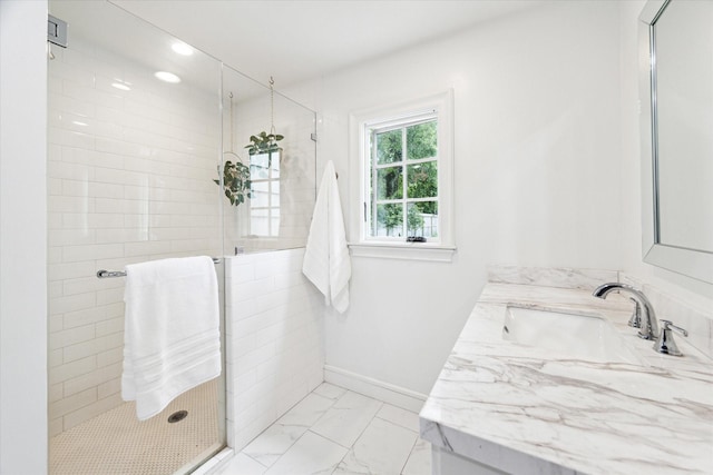 bathroom featuring walk in shower and vanity