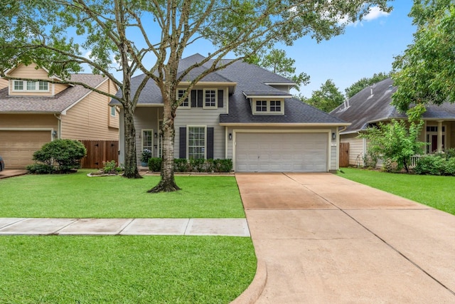 view of front facade with a garage and a front lawn