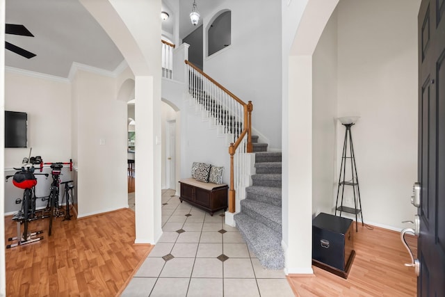 foyer featuring crown molding and light hardwood / wood-style flooring