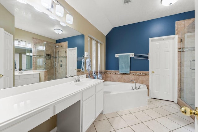 bathroom with tile patterned floors, vanity, lofted ceiling, and separate shower and tub