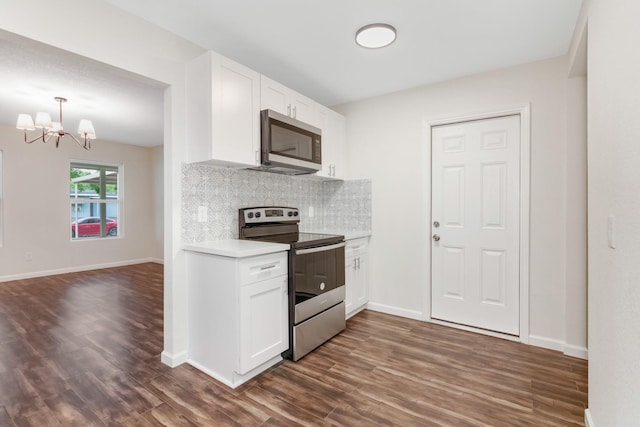 kitchen featuring appliances with stainless steel finishes, decorative backsplash, decorative light fixtures, a chandelier, and white cabinets