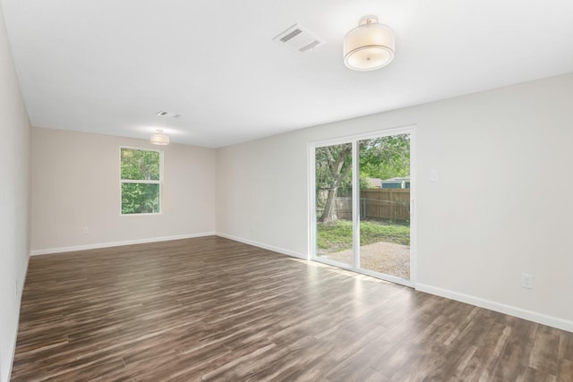 spare room with dark wood-type flooring