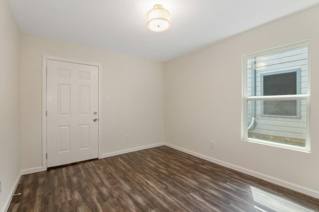 unfurnished room featuring dark hardwood / wood-style flooring