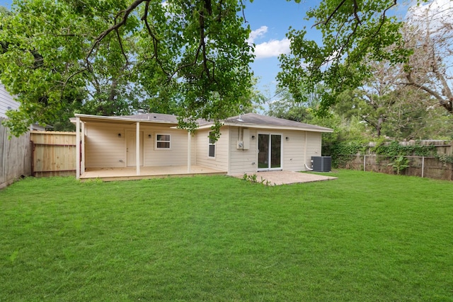 rear view of property with central air condition unit, a lawn, and a patio