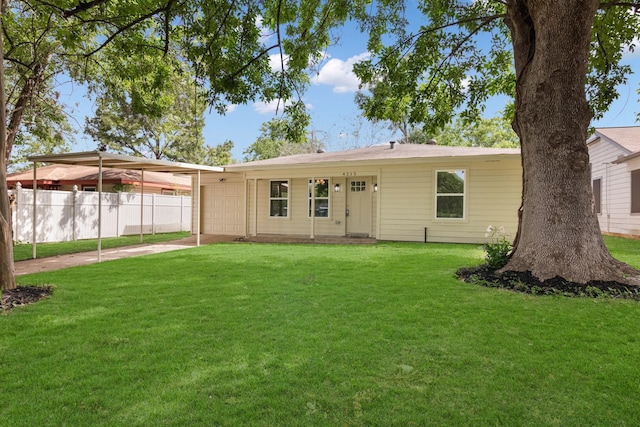 rear view of house with a lawn and a garage