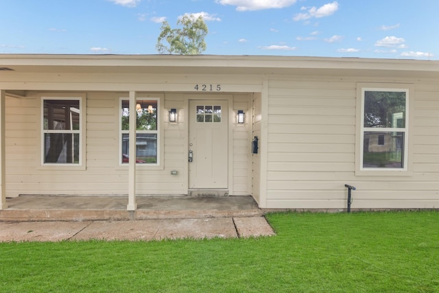 doorway to property with a lawn