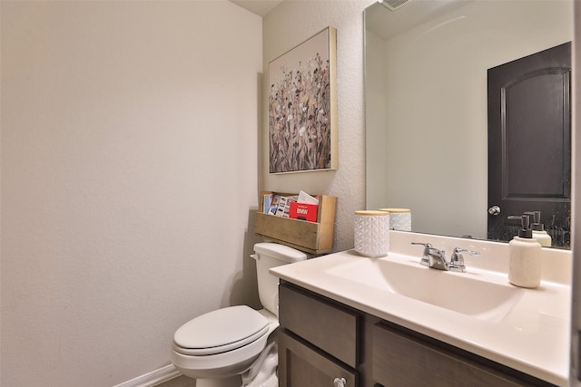 bathroom with toilet and vanity