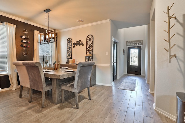 dining room featuring ornamental molding and a chandelier