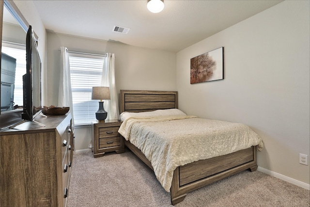 carpeted bedroom with multiple windows