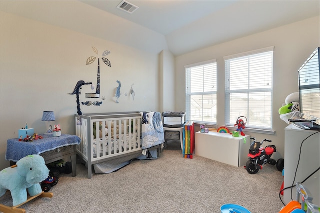 carpeted bedroom with a nursery area