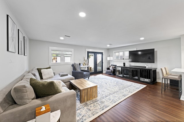 living room featuring french doors, a healthy amount of sunlight, and dark hardwood / wood-style floors