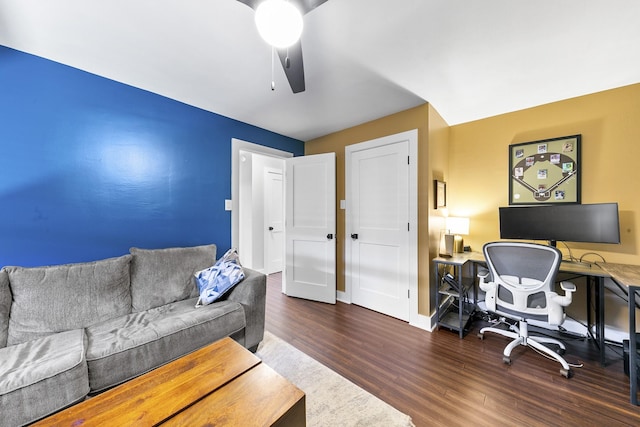 home office with ceiling fan and dark hardwood / wood-style flooring