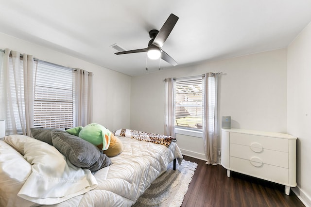 bedroom with ceiling fan and dark hardwood / wood-style flooring