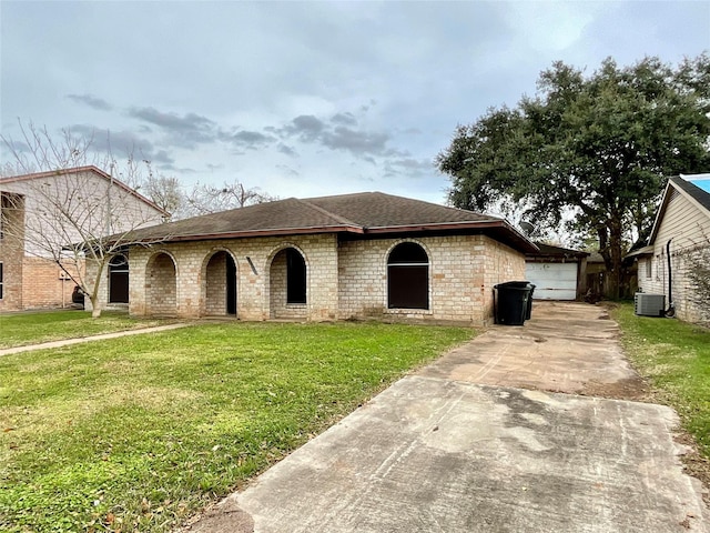 single story home with a garage, cooling unit, and a front lawn