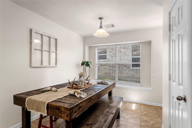 tiled dining room featuring a wealth of natural light