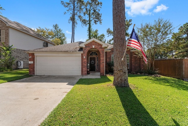 view of front of home featuring a front yard and a garage