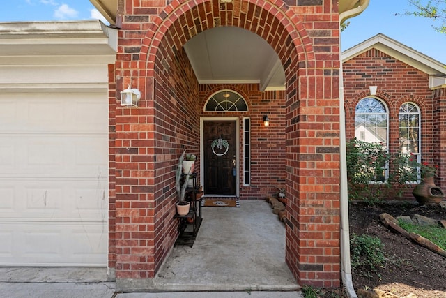 view of exterior entry with a garage