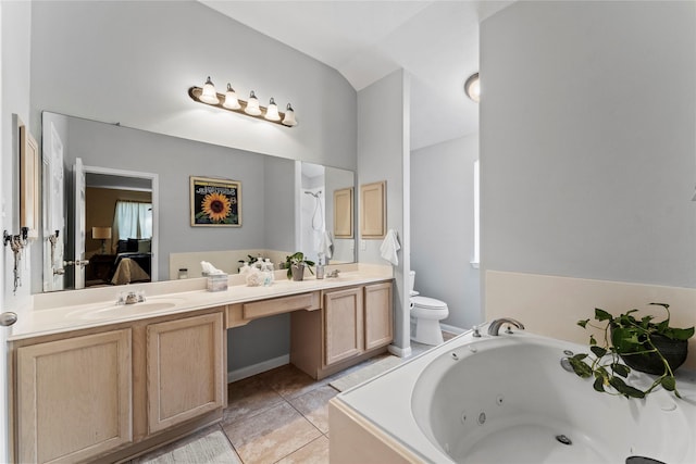 bathroom with toilet, vanity, vaulted ceiling, tile patterned floors, and tiled tub