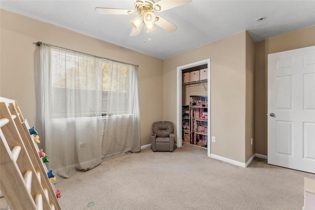 unfurnished room featuring light carpet and ceiling fan