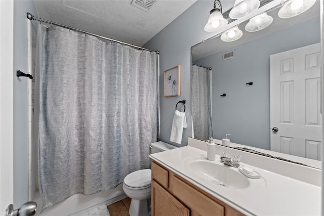 full bathroom featuring a textured ceiling, toilet, vanity, and shower / bath combination with curtain