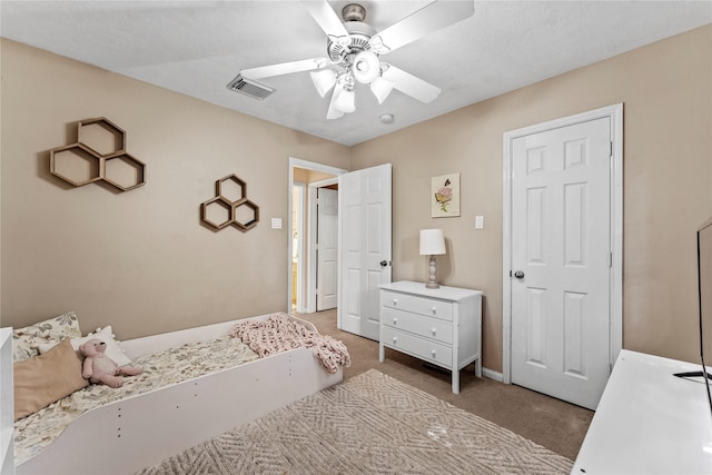 bedroom with ceiling fan and light colored carpet