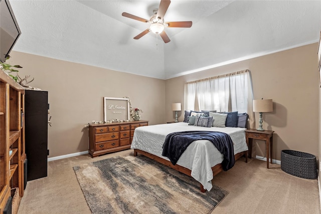 bedroom featuring ceiling fan, light carpet, and vaulted ceiling