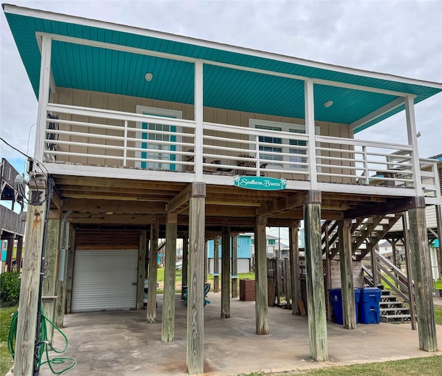 exterior space with stairs, a carport, and board and batten siding