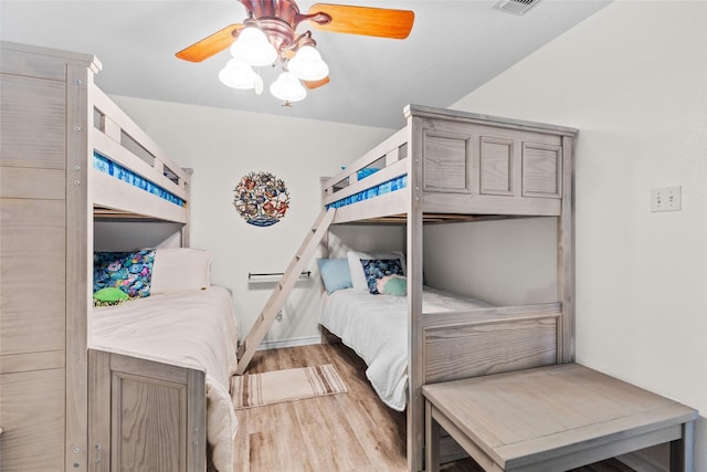 bedroom featuring visible vents, wood finished floors, and a ceiling fan