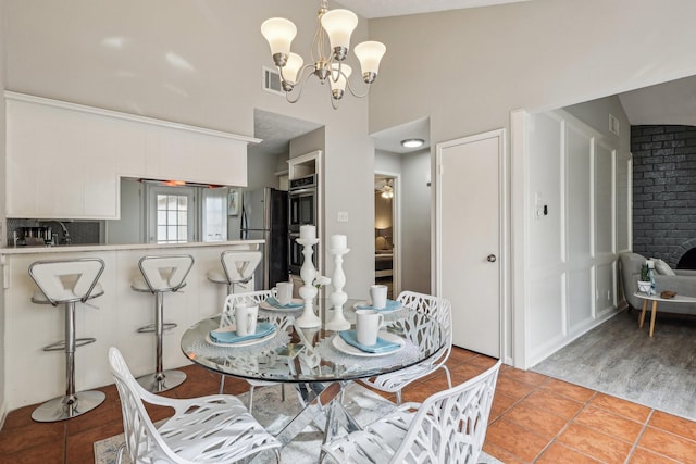 dining area featuring an inviting chandelier and light tile patterned floors