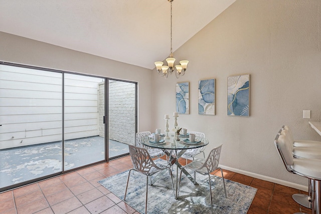 dining space featuring tile patterned floors, a chandelier, and vaulted ceiling