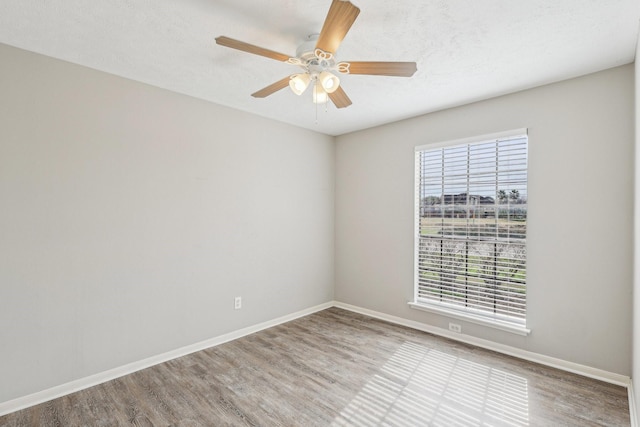 unfurnished room featuring ceiling fan and light hardwood / wood-style floors