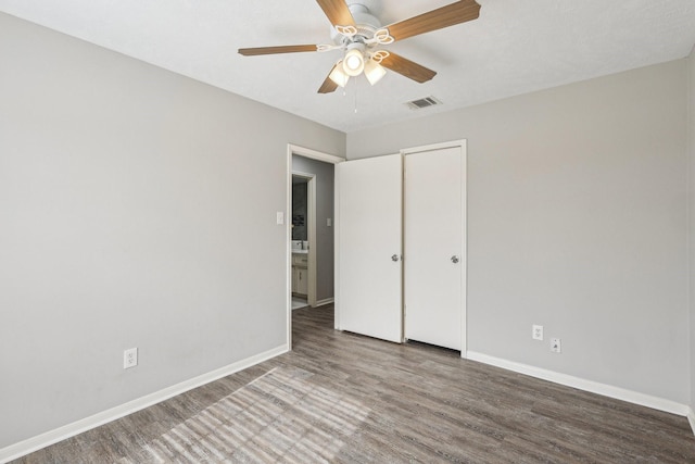 unfurnished bedroom with ceiling fan and hardwood / wood-style floors