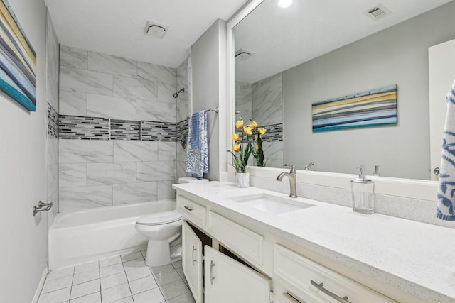 full bathroom with tile patterned floors, toilet, vanity, and tiled shower / bath