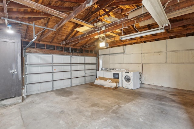 garage featuring washer and clothes dryer and a garage door opener