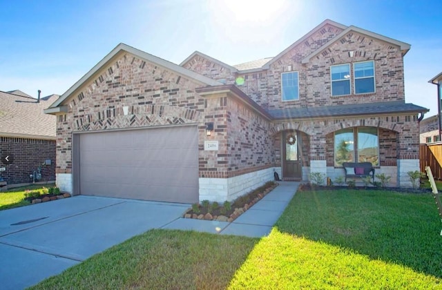 view of front of home with a front lawn and a garage