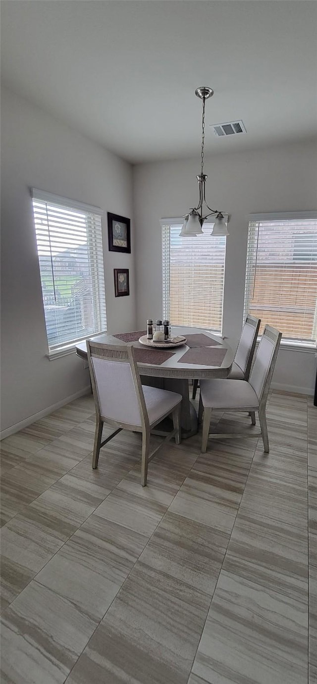 dining space featuring light tile patterned floors