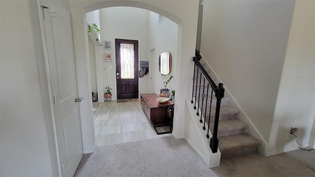 foyer entrance with light carpet