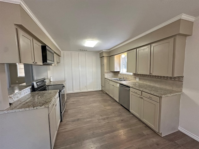 kitchen featuring hardwood / wood-style flooring, plenty of natural light, appliances with stainless steel finishes, and sink