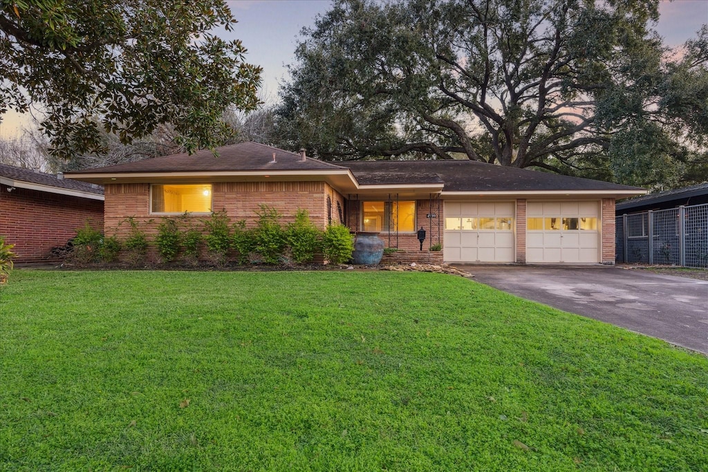 view of front facade featuring a garage and a yard