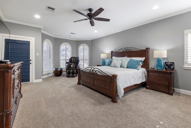 bedroom with ceiling fan, light colored carpet, and crown molding