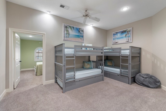 bedroom with ceiling fan and light carpet