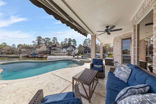 view of pool featuring ceiling fan, an in ground hot tub, a water view, a patio area, and an outdoor hangout area