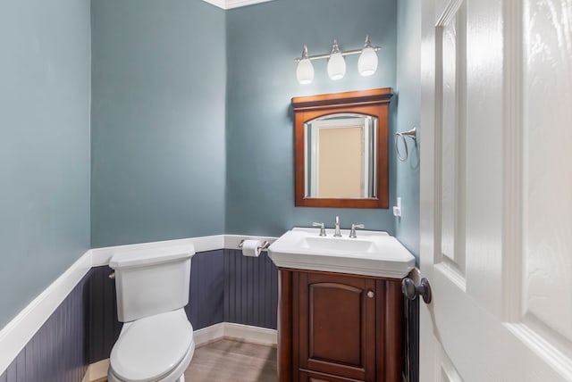 bathroom featuring toilet and vanity